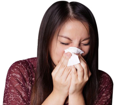Woman sneezing due to indoor allergens